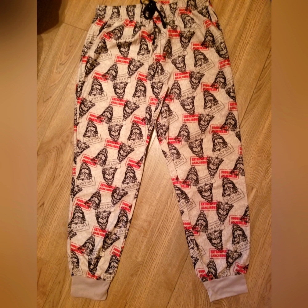 Womens cozy fleece pajama bottoms in red & black Batman foe motif on grey back